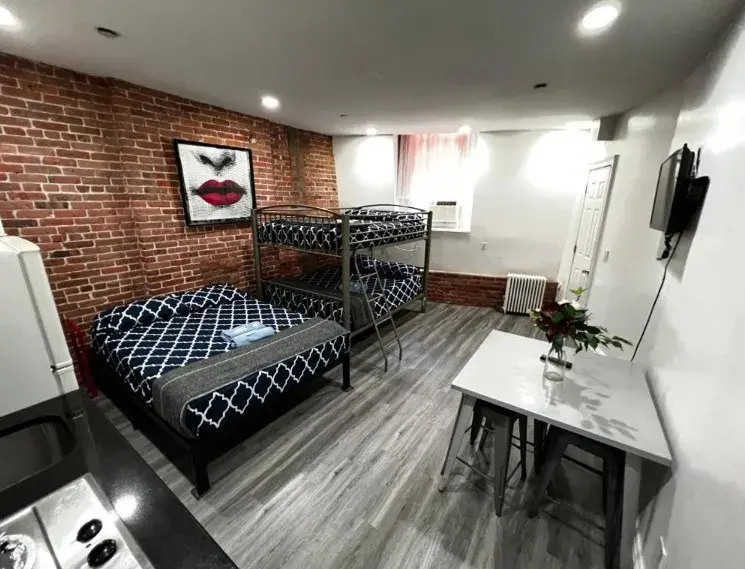 Queen Studio with a full bed, a bunk bed and a table