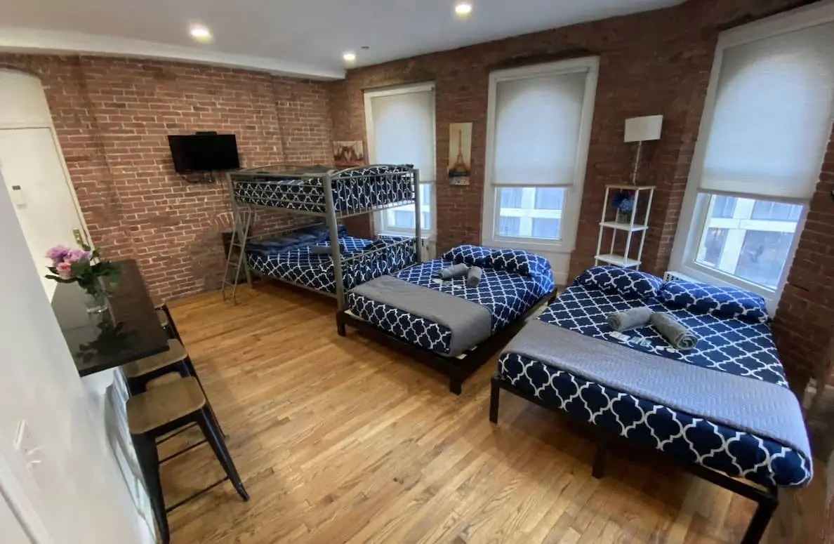 Room with a bunk bed and two double beds by the windows
